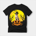 Black t-shirt printed with an Australian Shepherd in a witch's hat sitting on a carved Halloween pumpkin, with bats and bare trees under a full moon