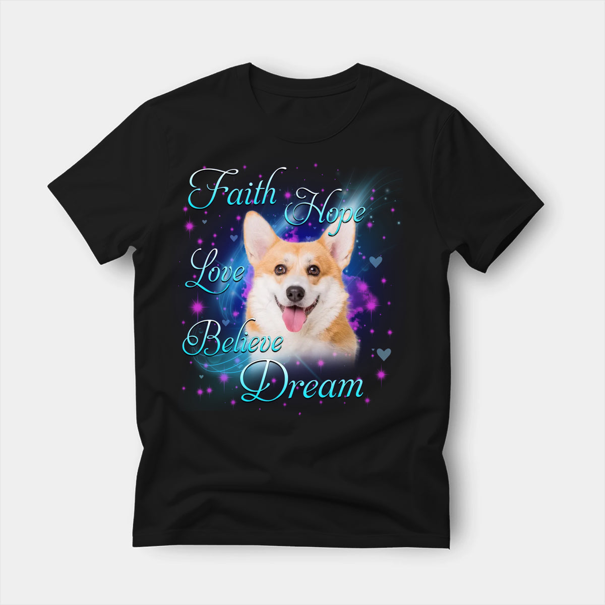 Black t-shirt printed with a Pembroke Welsh Corgi with the words Faith, Hope, Love, Believe and Dream in glowing script on a sparkling blue background