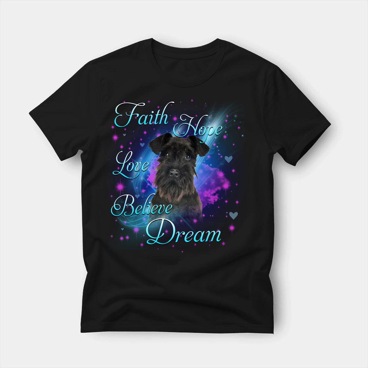 Black t-shirt printed with a Schnauzer with the words Faith, Hope, Love, Believe and Dream in glowing script on a sparkling blue background