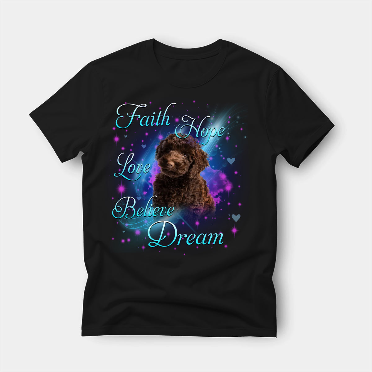 Black t-shirt printed with a Poodle with the words Faith, Hope, Love, Believe and Dream in glowing script on a sparkling blue background